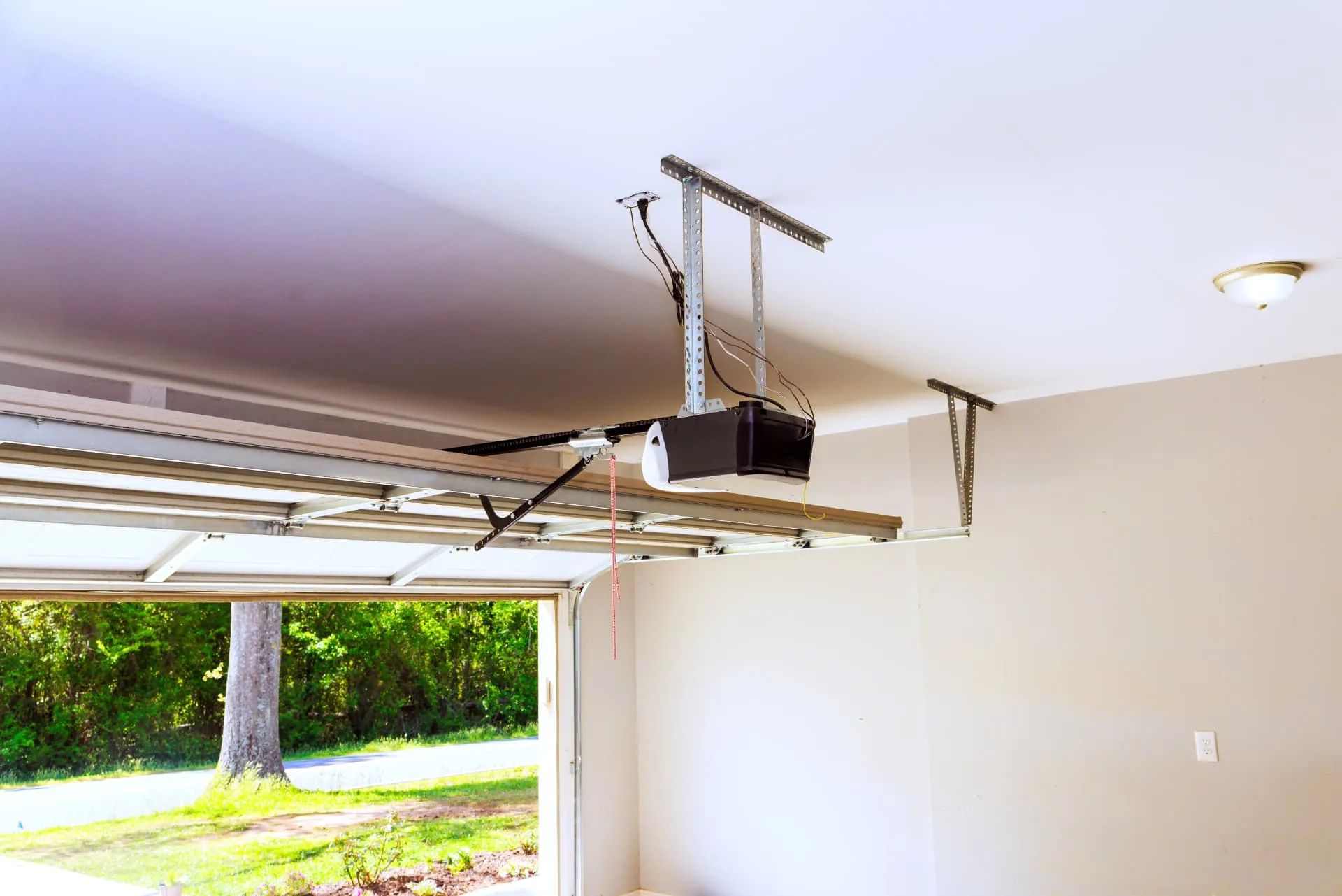 Garage door opener rail and open sectional door serviced in New River, AZ